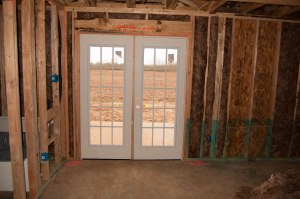 Double doors in the master bedroom to the patio in the back of the house. 
